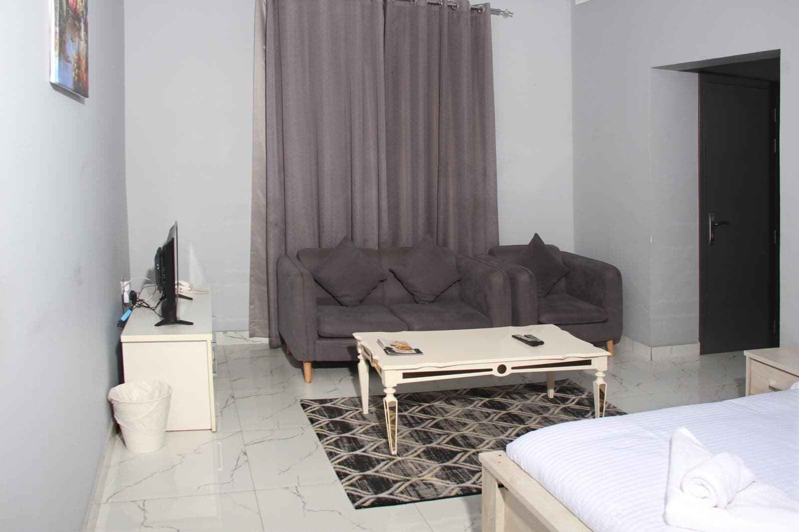 Furnished living and bedroom spaces at PARIS Furnished Apartments LLC